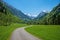 Stunning spring landscape, Trettach  valley and walkway, view to snowy allgau alps