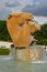 Stunning statue pf two golden color horse heads in big park with little fountain