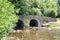 Stunning stone bridge spanning across a tranquil stream