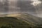 Stunning Summer landscape image of escarpment with dramatic storm clouds and sun beams streaming down