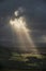 Stunning Summer landscape image of escarpment with dramatic storm clouds and sun beams streaming down