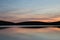 Stunning Summer sunrise landscape of colors reflected in Llyn Cw