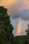 Stunning Summer sunset sky with heart shaped cloud and colorful vibrant clouds and sun beams across whole sky