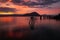 A stunning sunset across the flat calm waters just off the coast of Wrangell, Alaska, the sky appears to be on fire and the