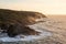 Stunning sunset landscape image of Cornwall cliff coastline with tin mines in background viewed from Pendeen Lighthouse headland