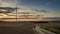 Stunning sunset over a field with a windmill in autumn, timelapse