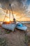 Stunning sunset over old fishing boats on the shore at West Mersea