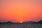 A stunning sunset over Phuket provides the backdrop to a traditional longtail boat, Phuket, Thailand