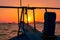 A stunning sunset over Phuket provides the backdrop to a traditional longtail boat, Phuket, Thailand