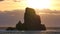 Stunning sunset in Talisker bay on west coast of the Isle of Skye in Scotland during an windy sunset. Sharp rocky tower above sea