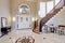 Stunning two story entry foyer with marble mosaic tiled floor