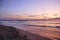 Stunning vibrant Gold sunrise on the sand beach .Orange sunrise color