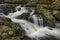 Stunning vibrant landscape image of Aira Force Upper Falls in Lake District during colorful Autumn showing