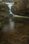 Stunning vibrant landscape image of Aira Force Upper Falls in Lake District during colorful Autumn showing