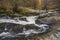 Stunning vibrant landscape image of Aira Force Upper Falls in Lake District during colorful Autumn showing