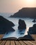 Stunning vibrant sunset landscape image of Kynance Cove on South Cornwall coast of England coming out of pages of open story book