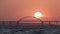 Stunning view of the beautiful sunset over the big river and the bridge, time lapse effect. Shot. Bright golden sun