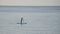 Stunning view of a female floating on the surfboard over the sea