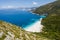 Stunning view of Fteri beach with white sailboat in hidden bay, Kefalonia, Greece. Surrounded by mediterranean