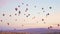 Stunning view of numerous colourful balloons flying in the air during calm sunrise. Cappadocia - one of the most popular