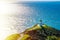 Stunning view over Cape Reinga Lighthouse and a winding path leading to it. Famous tourist attraction at Cape Reinga