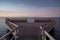 Stunning view of a pier illuminated by the vibrant colors of an aurora in the night sky