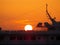 Stunning View of the Setting Sun over the Yacht at the Old Port of Mykonos town, Greece