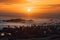 stunning view of sunset over the ocean with a herd of ibex in the foreground