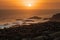 stunning view of sunset over the ocean with a herd of ibex in the foreground