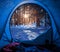Stunning view from tent to snowy forest in winter
