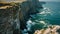 A stunning view of towering cliffs that provide a dramatic backdrop to the expansive ocean, High angle shot of a sweeping sea