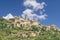 Stunning view of the Tuscan hilltop village of Montepulciano, Siena, Italy, on a sunny day with some white clouds