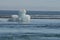 Stunning view of a unique iceberg with black sand in the background