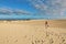 Stunning view of woman walking on Corralejo Dunas beach, Fuerteventura, Canary Islands