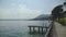 Stunning view of wooden pier on lake Garda and Monte Baldo mountains, landscape