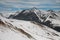 Stunning views of magnificent winter mountains with snow and blue sky with clouds