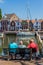 Stunning views over historic dutch yacht harbour watched by senior males sitting on bench