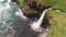 Stunning waterfall splashing from cliff aerial view. Mulafossur waterfall near Gasadalur Village at Faroe Islands