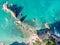 Stunning wide angle aerial drone view of a rock in the water at Otama Beach near Matarangi on the Coromandel Peninsula in New Zeal