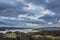 Stunning wide vista landscape view from Todd Crag in Lake District on a Winter evening with dramatic sky above