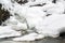 Stunning winter landscape, stones on wintry river covered snow a