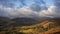 Stunning Winter sunrise golden hour landscape view from Loughrigg Fell across the countryside towards Langdale Pikes in the Lake