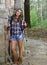 Stunning woman hiker in flannel with tekking poles