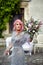 Stunning woman with pink hair stands with large wedding bouquet