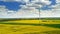 Stunning yellow rape fields and white turbine from above, Poland