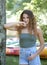 Stunning young brunette woman standing with bright canoes