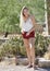 Stunning young Latina woman poses in red shorts - desert