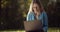 Stunning young woman studying at park with laptop