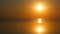 Stunningly beautiful scenic orange round sunset with a lot of sun on a calm, smooth lake