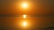 Stunningly beautiful scenic orange round sunset with a lot of sun on a calm, smooth lake